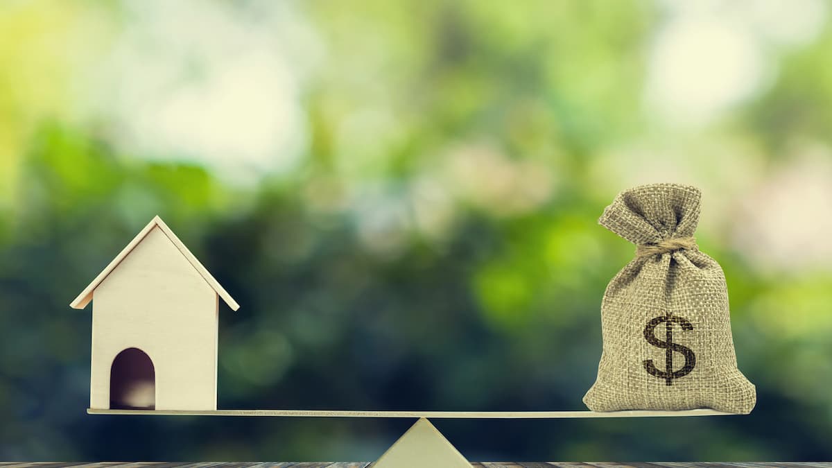 Collateral Requirements What Properties Qualify for Hard Money House model and money bag on seesaw