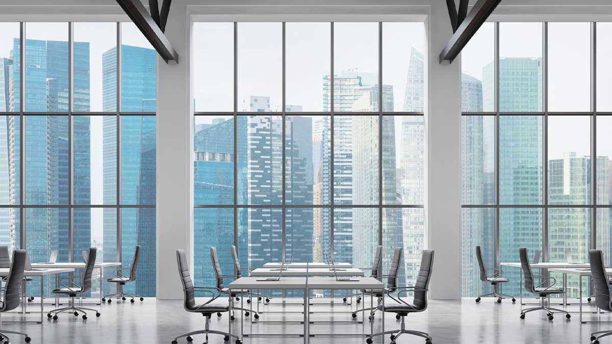 Commercial Real Estate Investment with Hard Money Financing Modern office interior with large windows overlooking a city skyline, symbolizing business growth and investment opportunities. The scene reflects Commercial Real Estate Investment with Hard Money Financing, highlighting private lending as a fast funding option for property investors and developers.